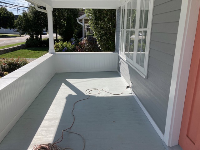 Front porch with worn floor before painting